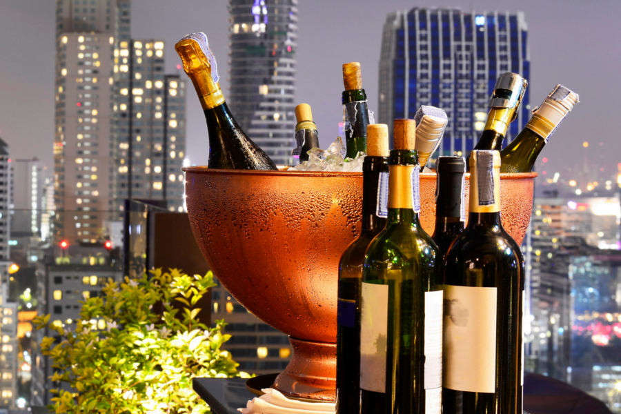 bottles of wine and champagne in a container with a city skyline